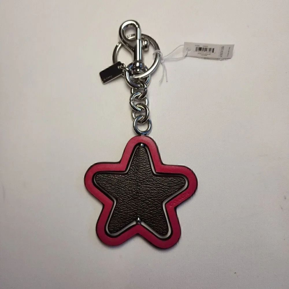 NWT Coach CP899 Spinning Star Bag Charm In Signature Canvas Bright Violet